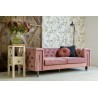 różowa tapicerowna sofa z metalowymi nogami